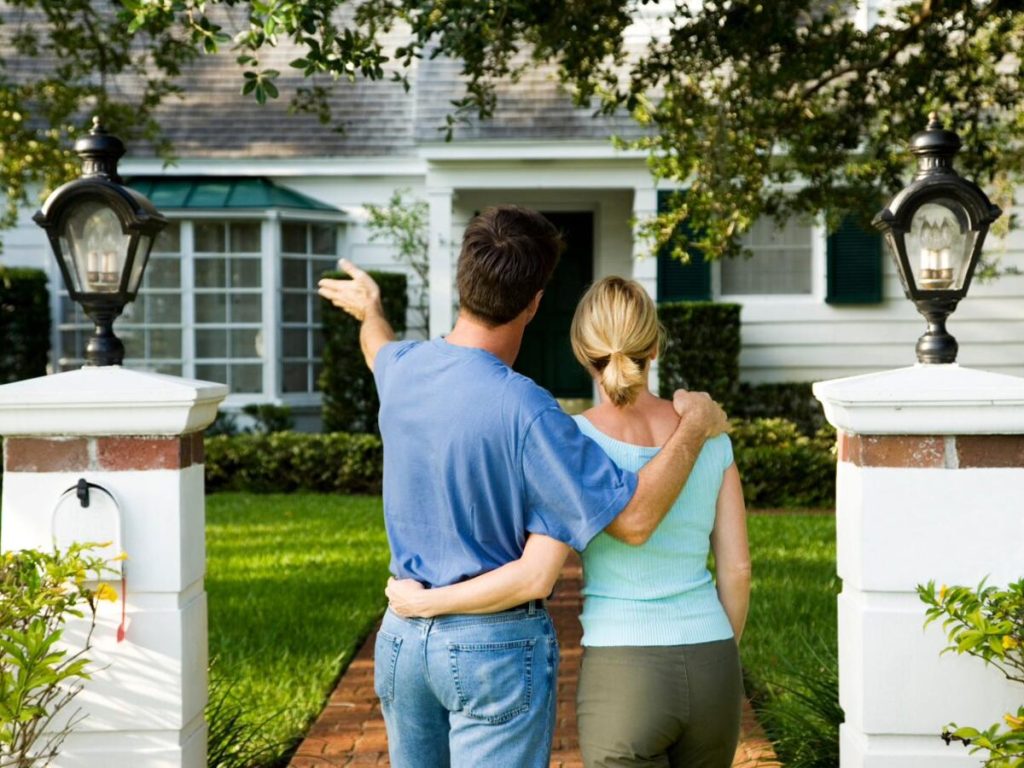 A couple standing at the entrance of a Charlotte home